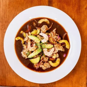 Authentic Sinaloa-style Aguachile with fresh lime-cured shrimp, buttery avocado, and crisp cucumber at Unos Mariscos O Que in Round Rock, TX.