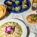From Mexico to Round Rock: The Heartfelt Story Behind Our Caldos de Mariscos High-quality seafood spread with shrimp aguachile, fresh ceviche tostadas, and oysters on a marble table at Unos Mariscos O Que.